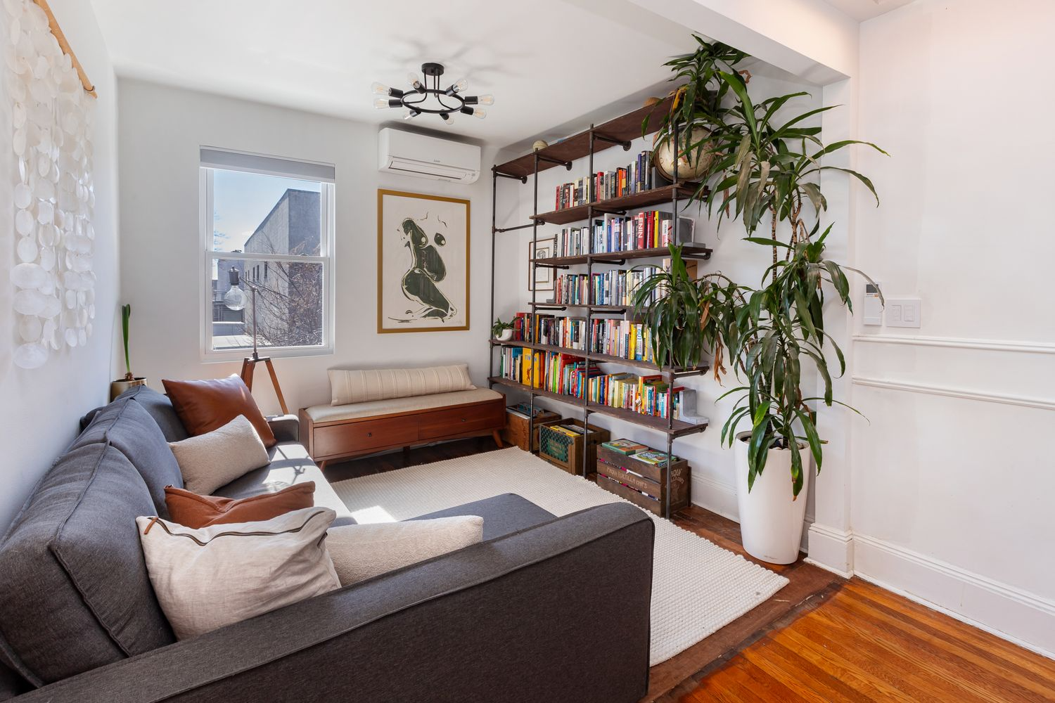 lounge nook with wood floor, white walls