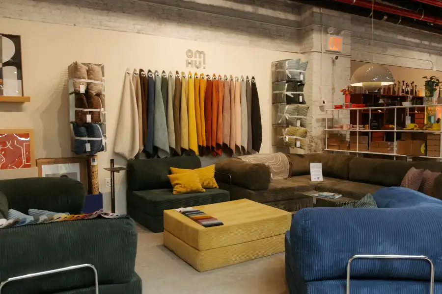store interior with fabric hanging on walls and a seating area