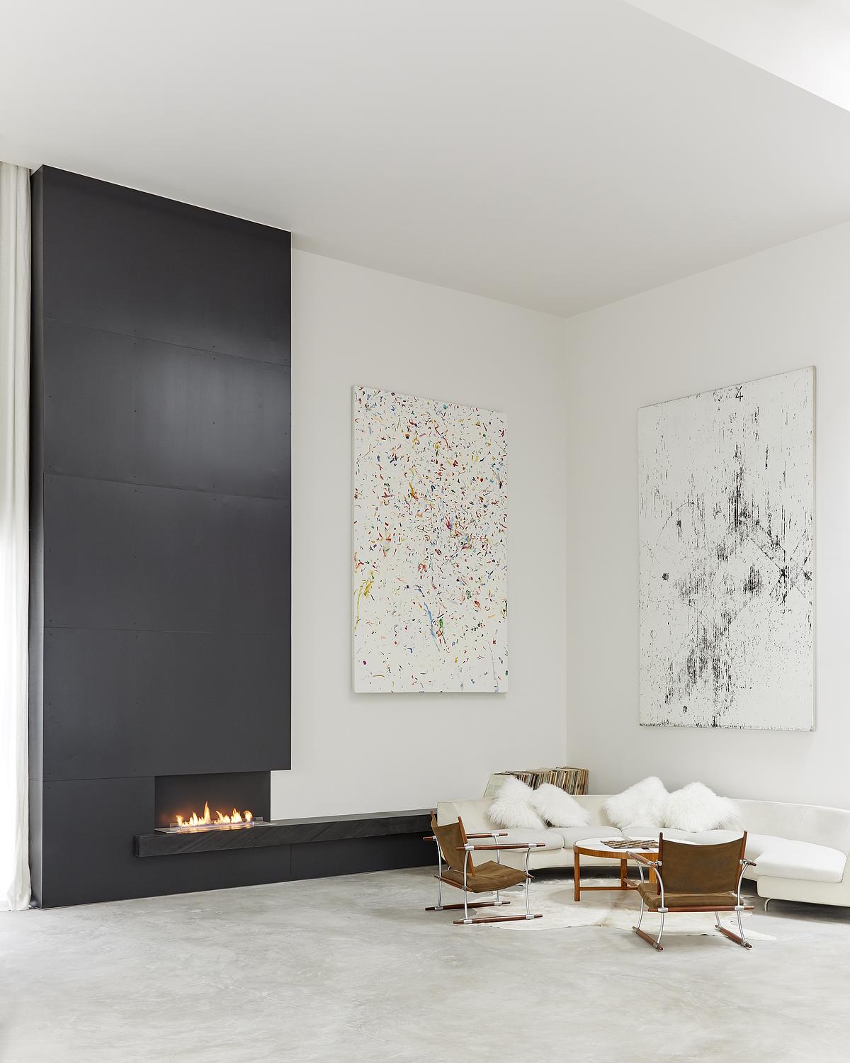 LIVING ROOM CORNER WITH BLACK FIREPLACE WALL