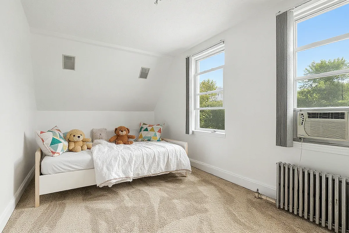 a virtually staged bedroom with a twin bed, carpeting and two windows