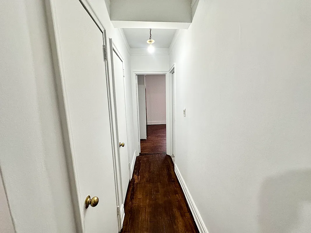 hallway to bedroom showing two closets