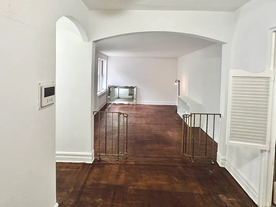view from foyer to sunken living room with curved railings on steps