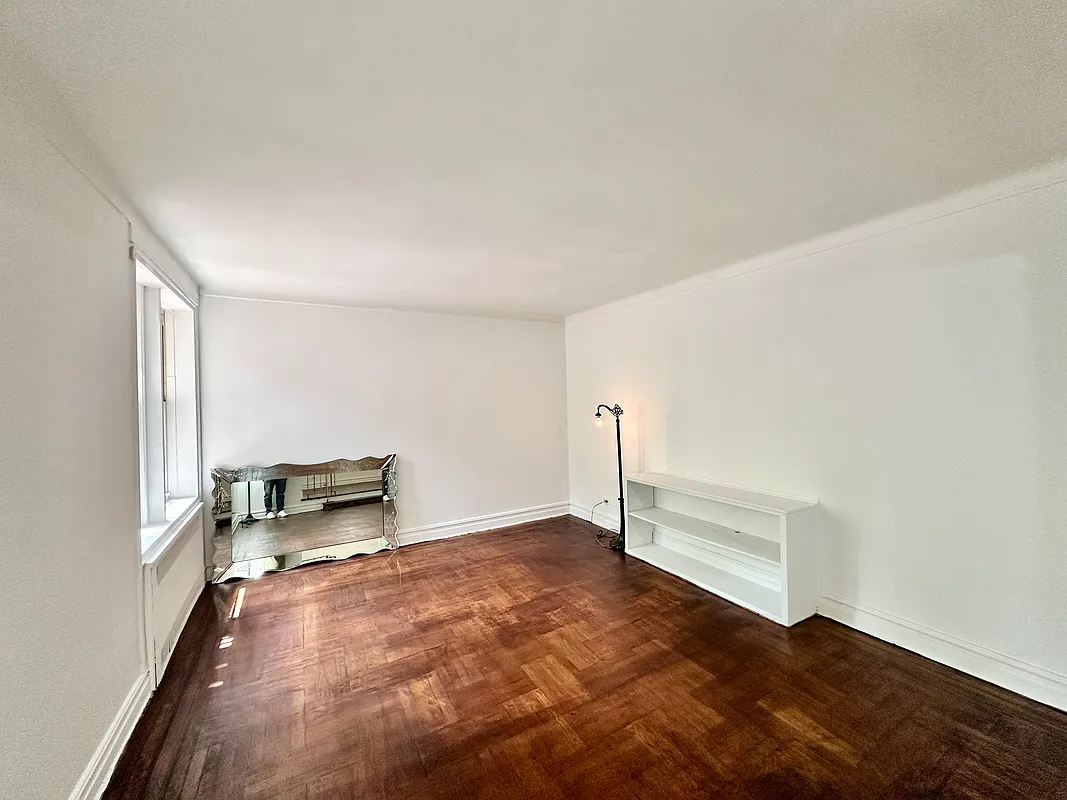 living room with wood floor, white walls