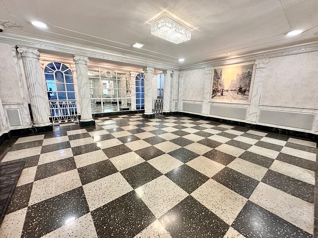 building lobby with checkerboard floor, columns