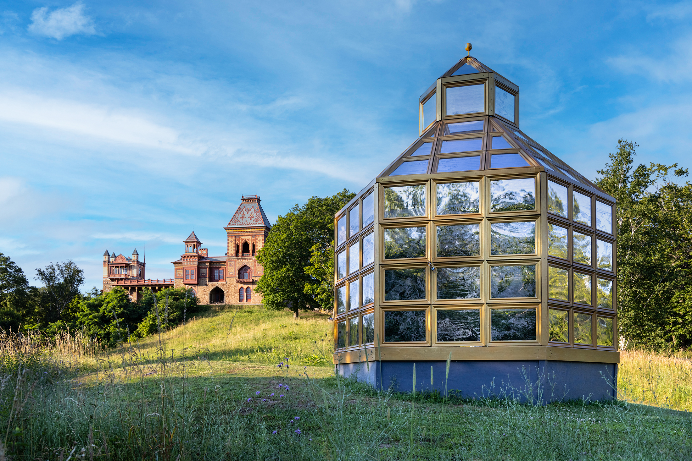 The art installation Winter in the Summer House by Ellen Harvey with a view of Olana beyond