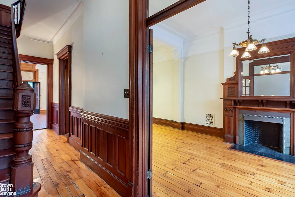 park slope - view from entry into a parlor with wood floor, wood mantel with mirror above