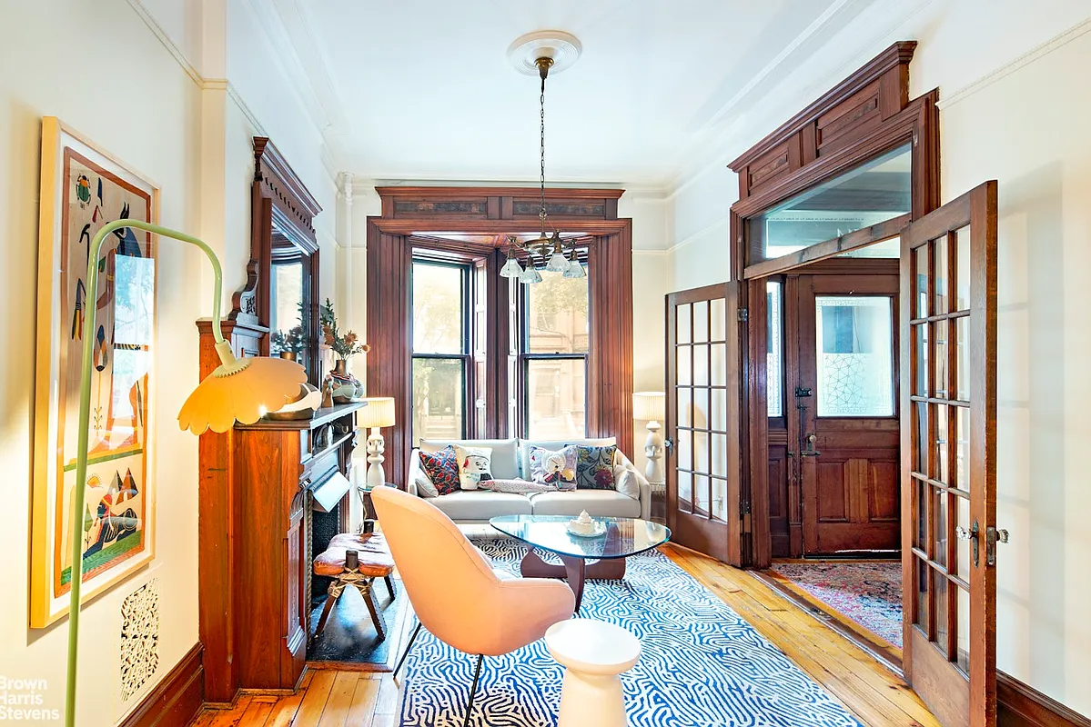 parlor with french doors to entry, mantel, moldings