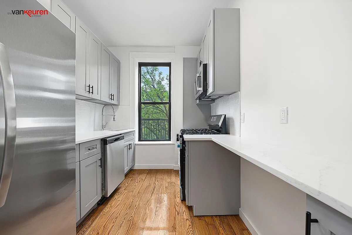 the kitchen with gray cabinets and white countertops