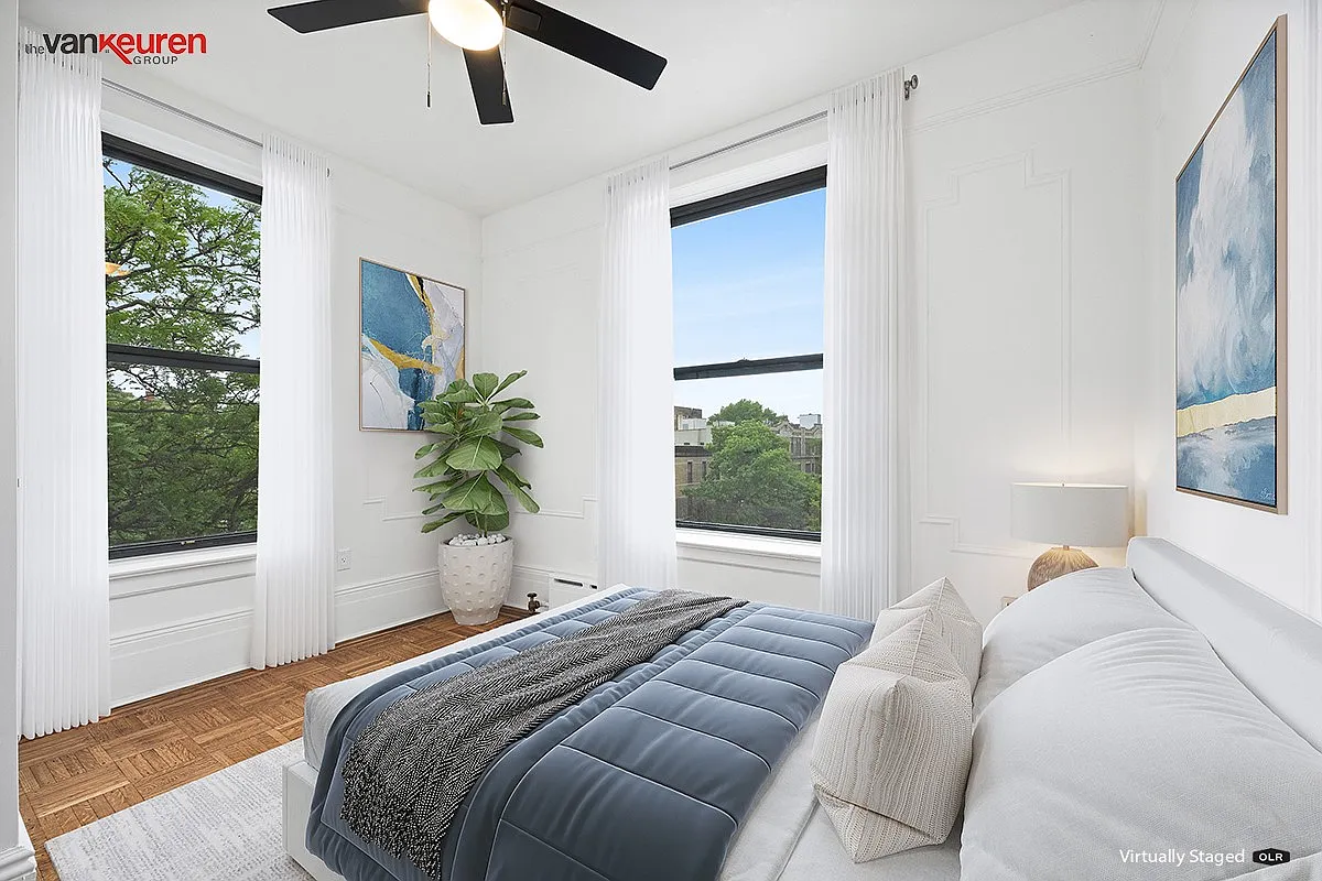 a virtually staged bedroom with two exposures and a ceiling fan