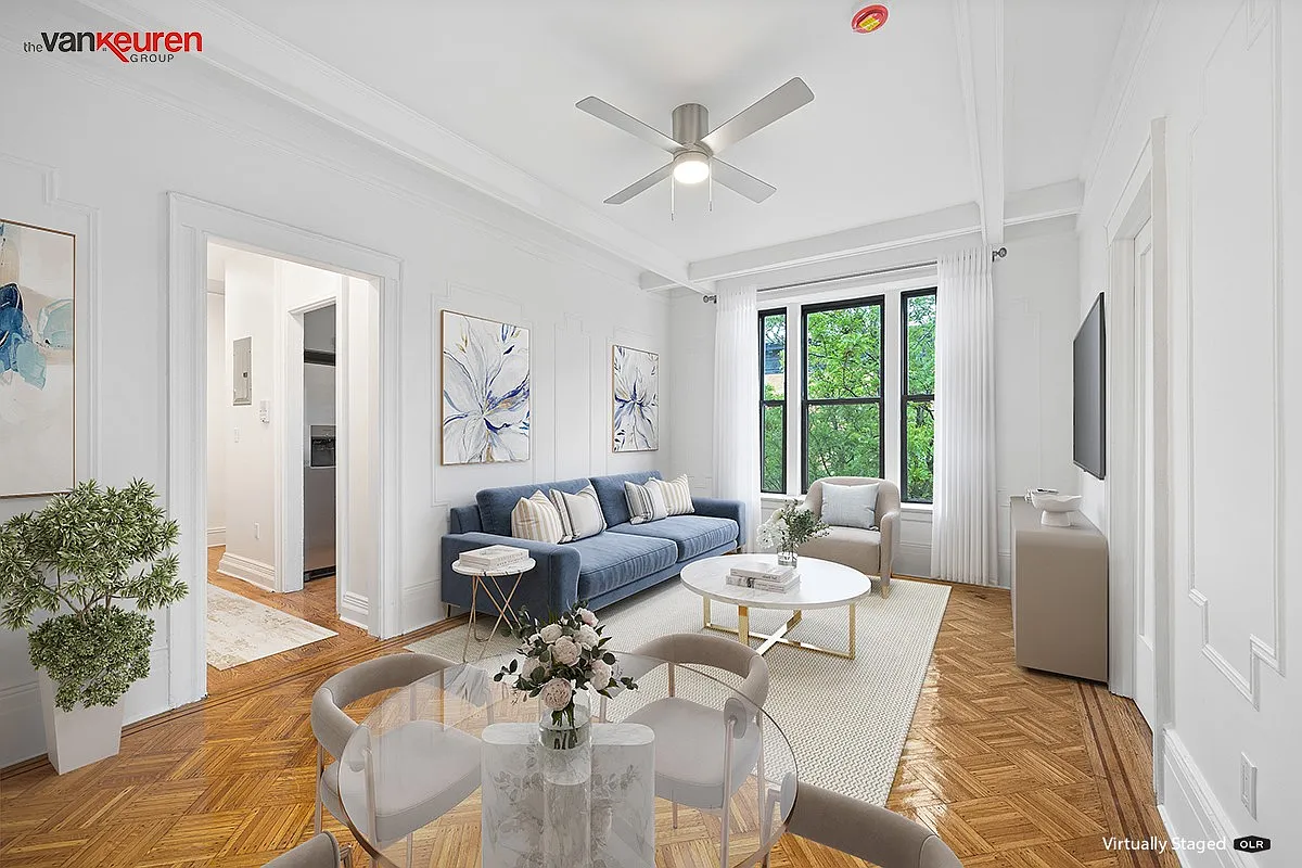 a virtually staged living room with a ceiling fan and room for a dining table