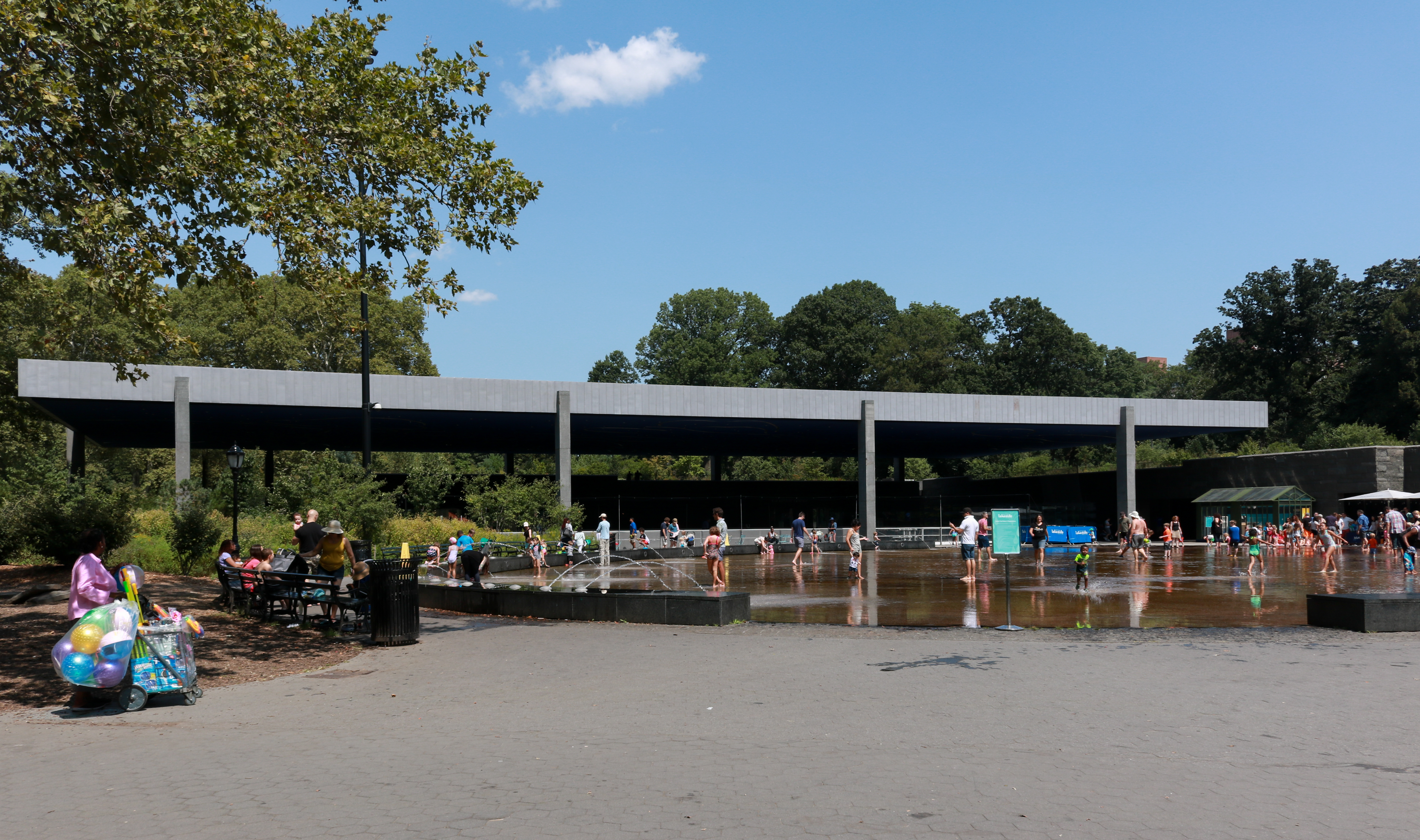 people playing in the water outside the lefrak center in prospect park