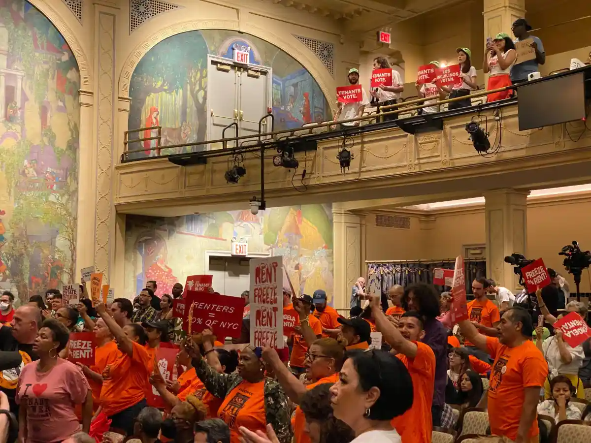 people in an audience holding signs