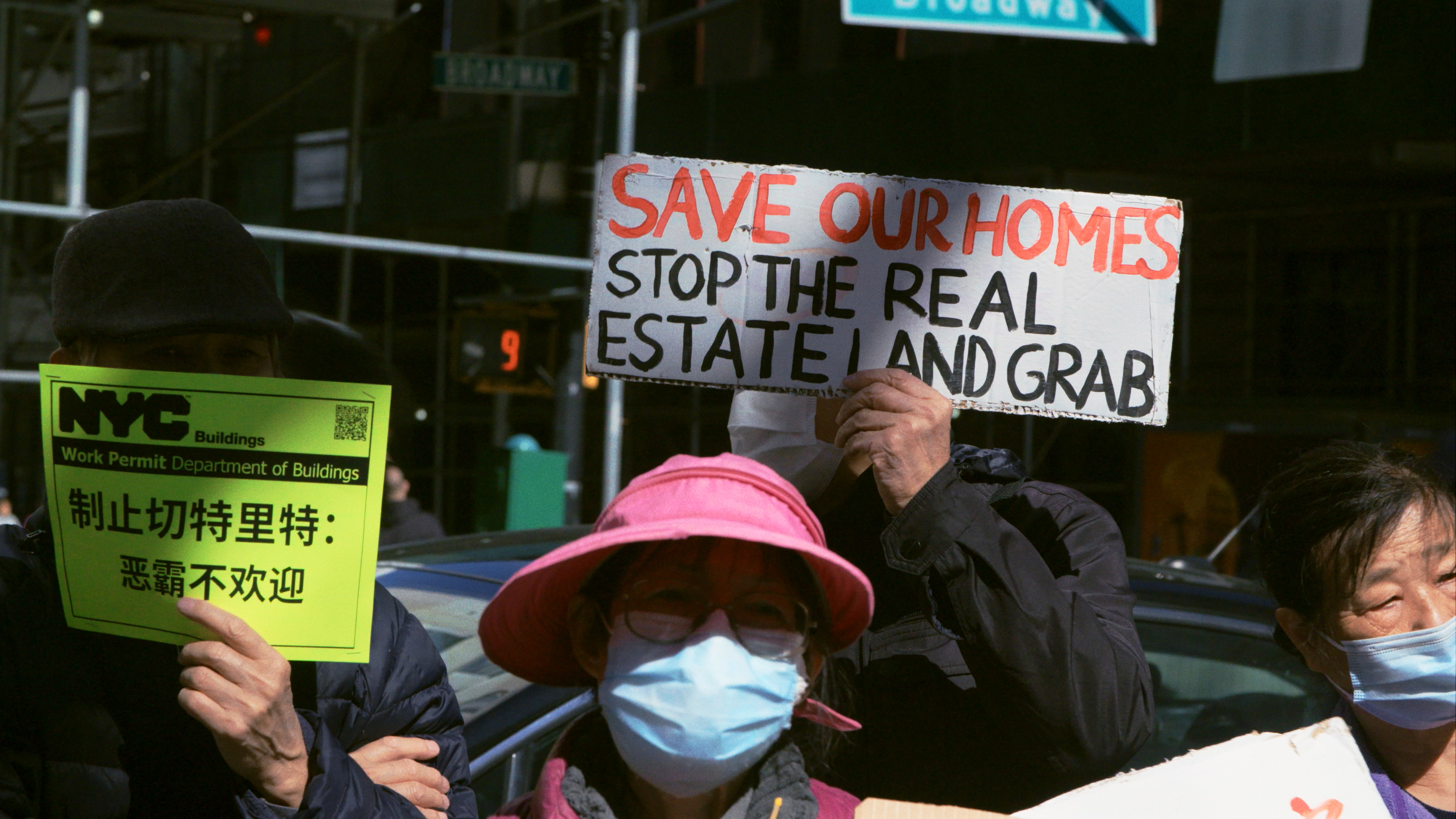 people hold signs of protest