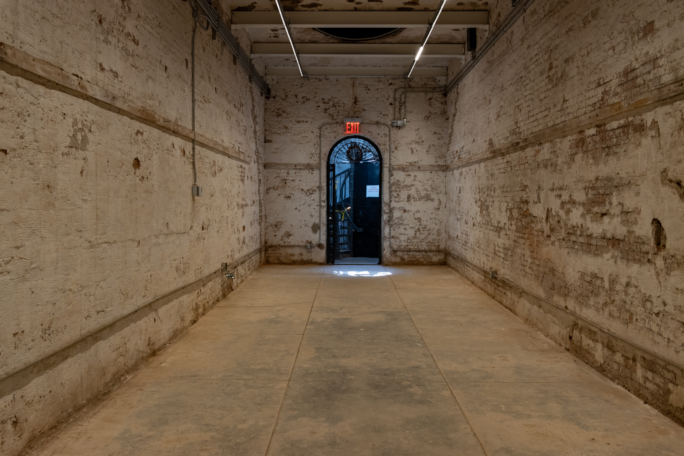 interior of the trophy room with brick walls and new strip lighting