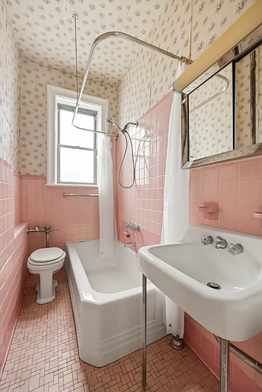 bathroom with white fixtures and pink wall and floor tile