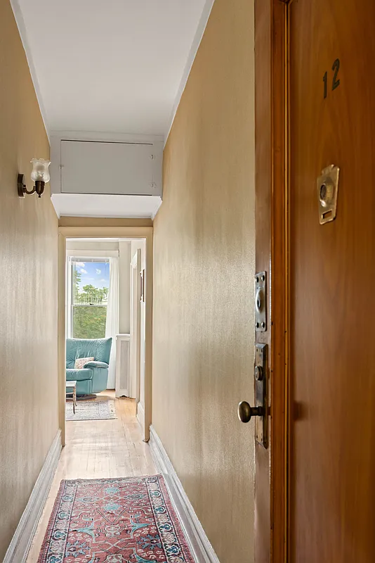 entry to apartment showing hallway leading to the living room