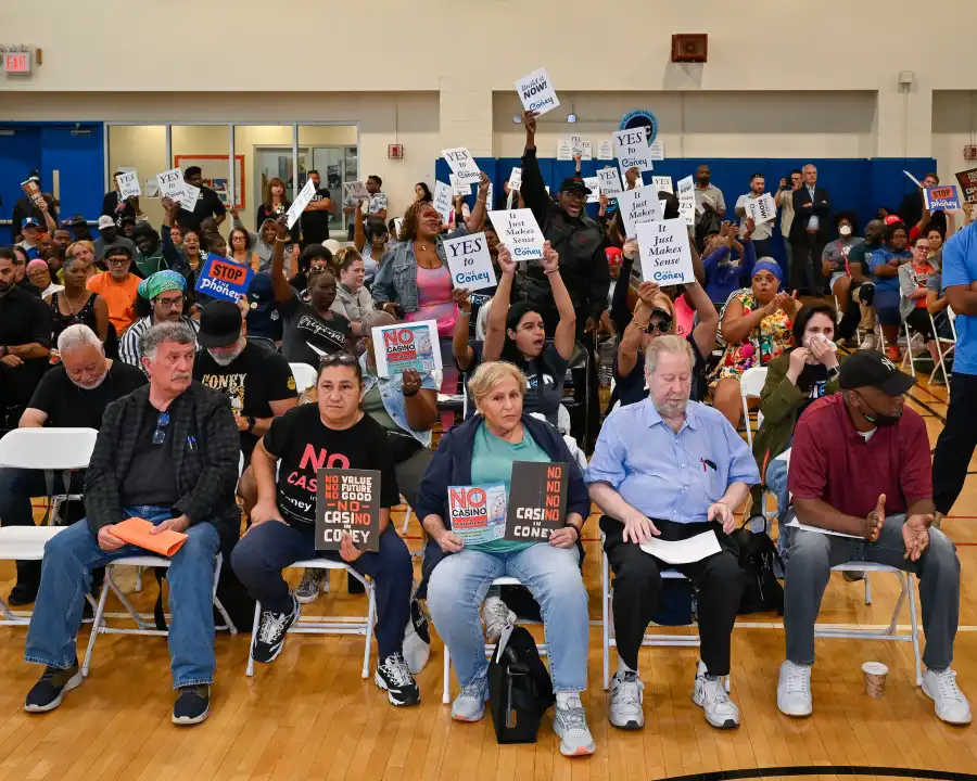 people holding signs in a meeting