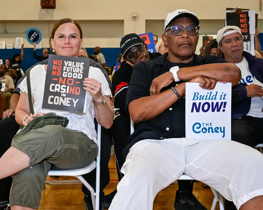 one person holding a sign supporting the casino and another person holding a sign opposing it