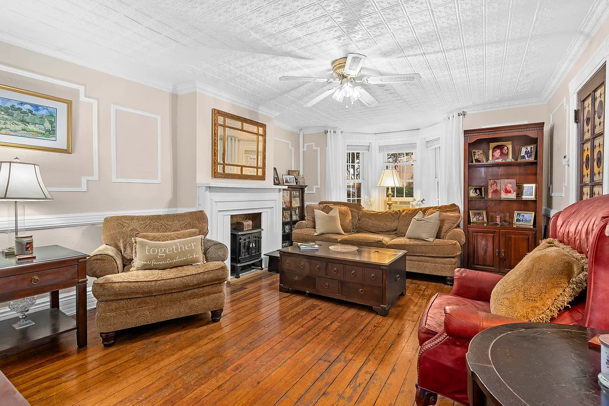 living room with wood floor, mantel