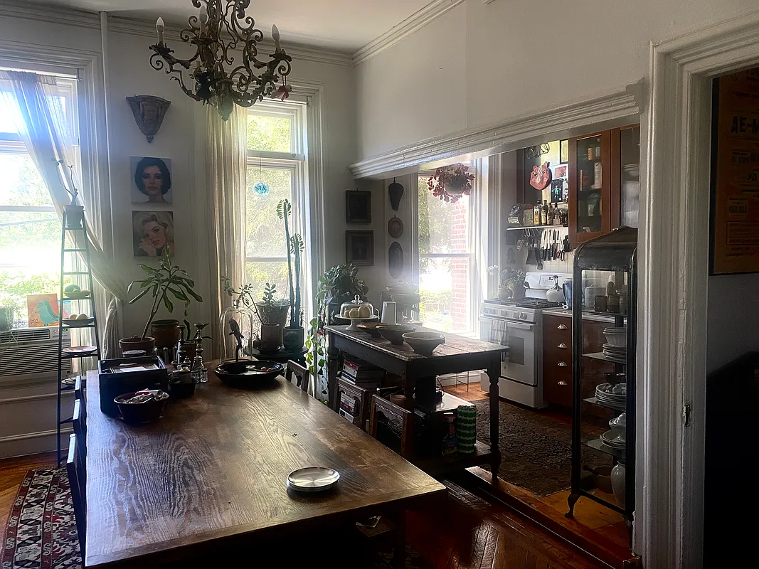 dining room and kitchen at the rear of the parlor level with wood floor, three windows
