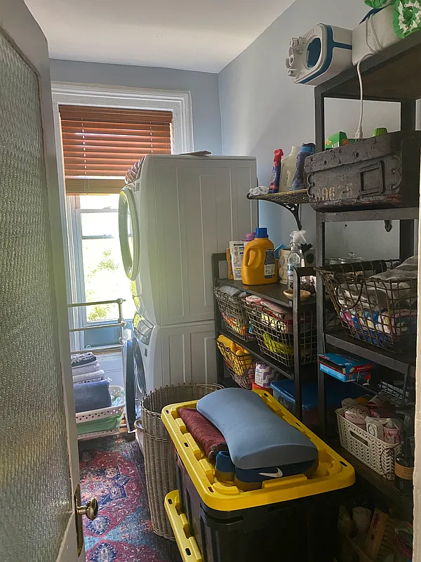 laundry room with stacked machines