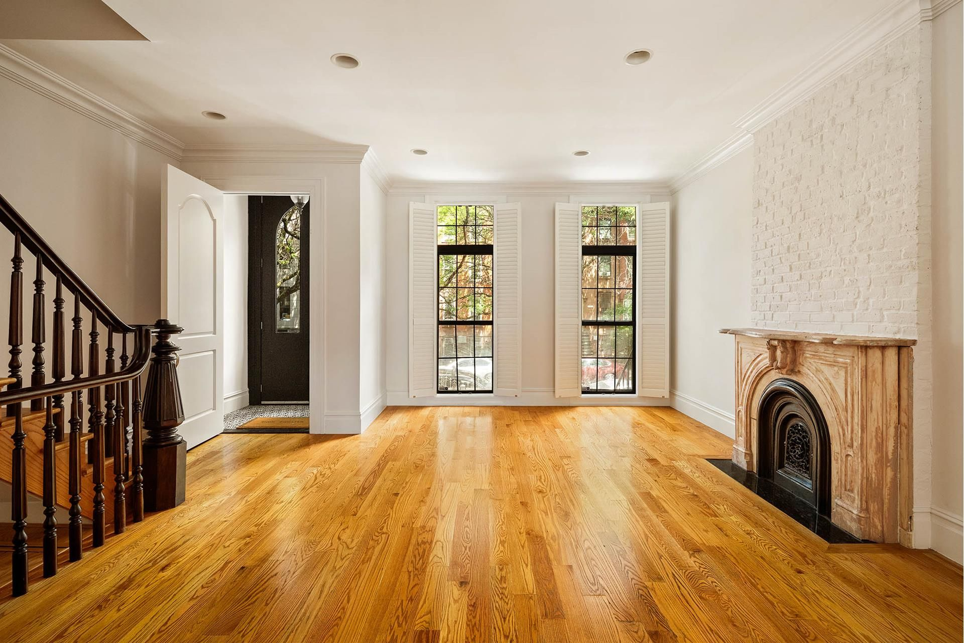 parlor with wood floors, a mantel