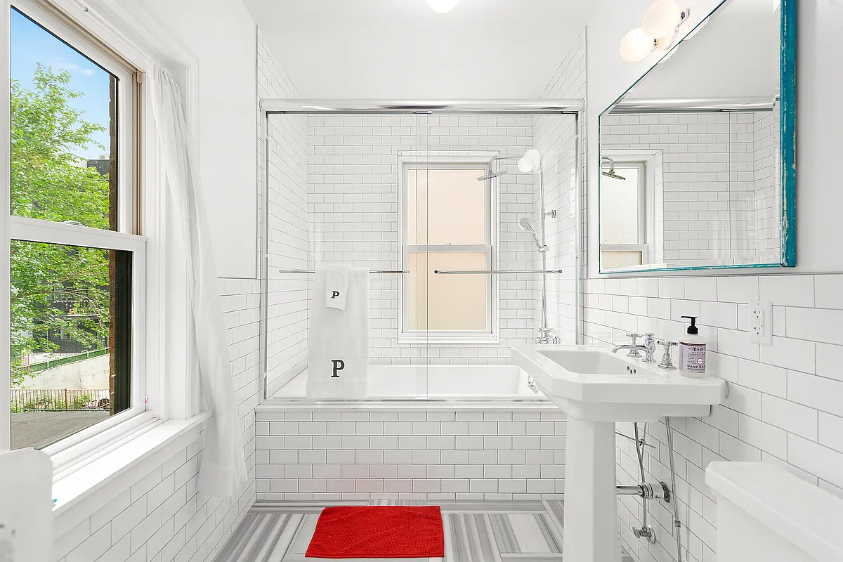 bathroom with white subway tile on walls and white fixtures