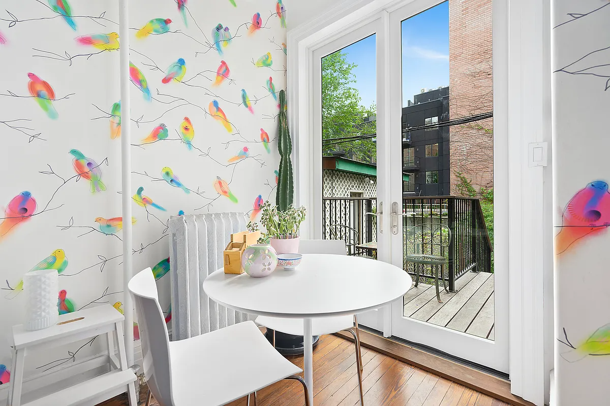 kitchen eating nook with bird wallpaper and doors to deck