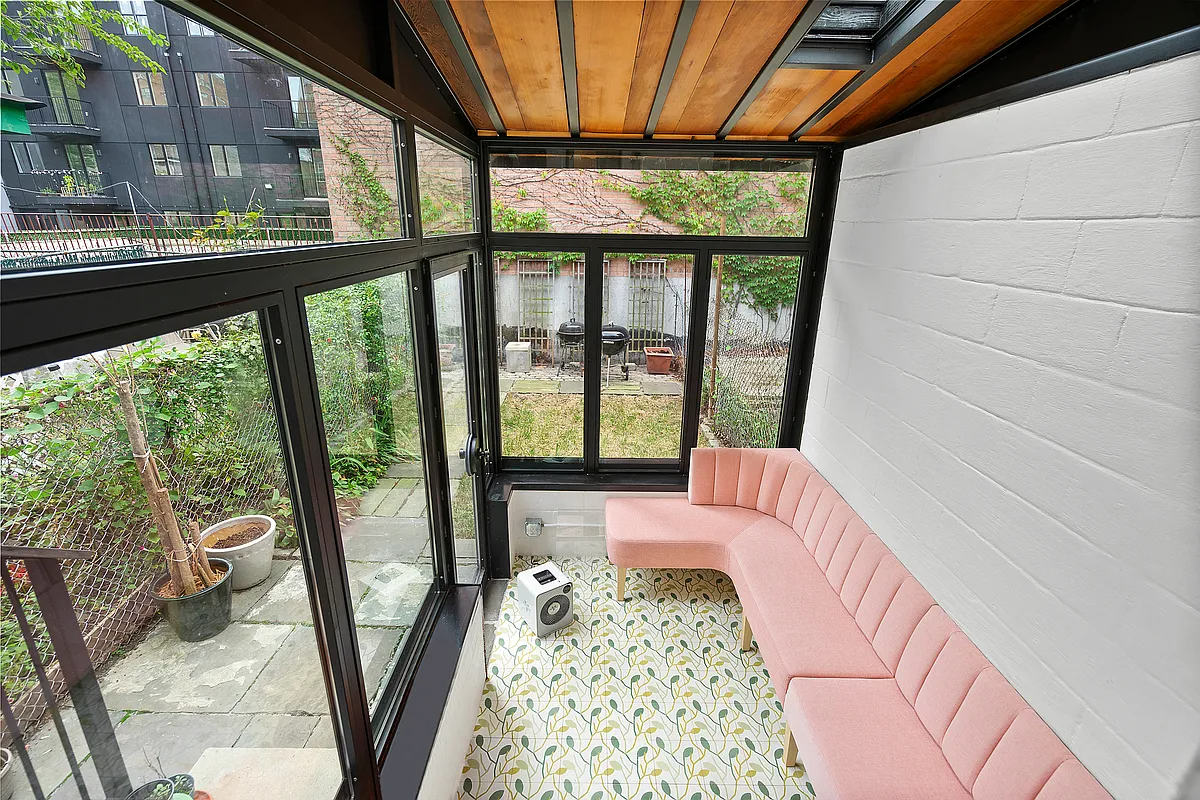 sun porch with walls of windows and a patterned tile floor