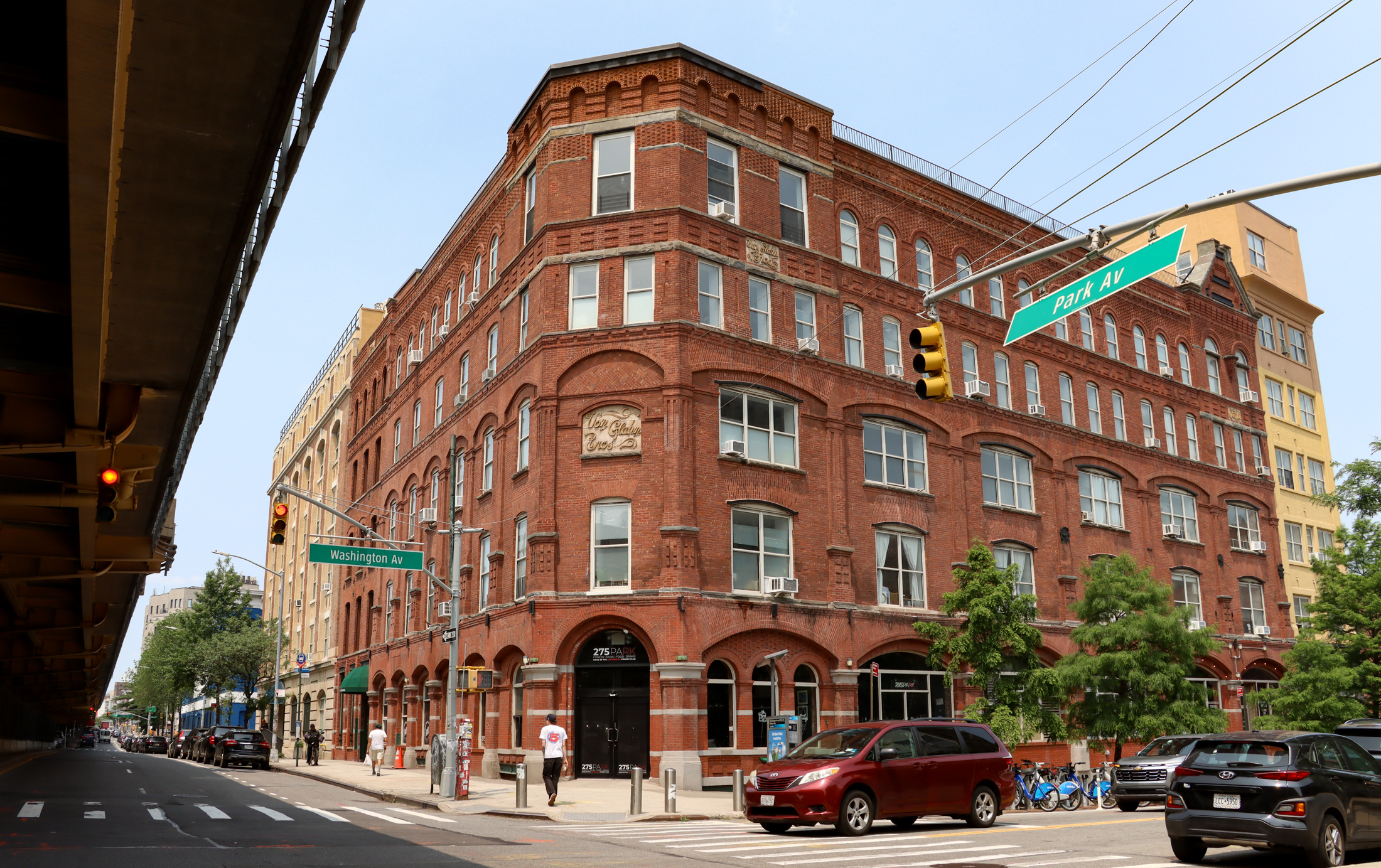 a brick building on a corner at the intersection of park and washington