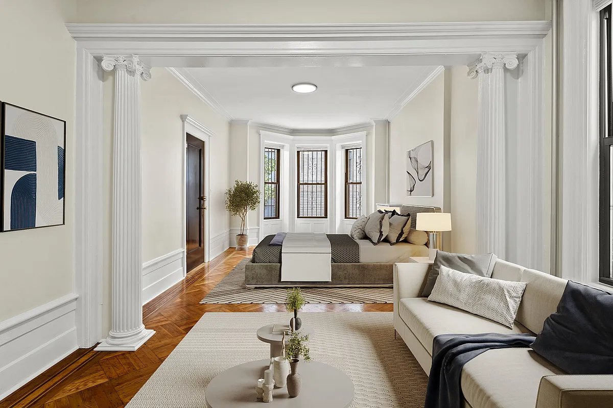 room with columned screen with bedroom on one side and living on the other