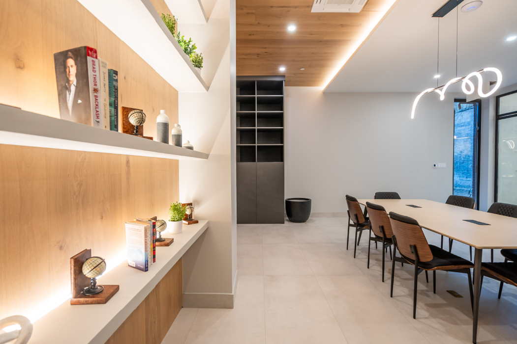 lounge or shared workspace with tables and shelving