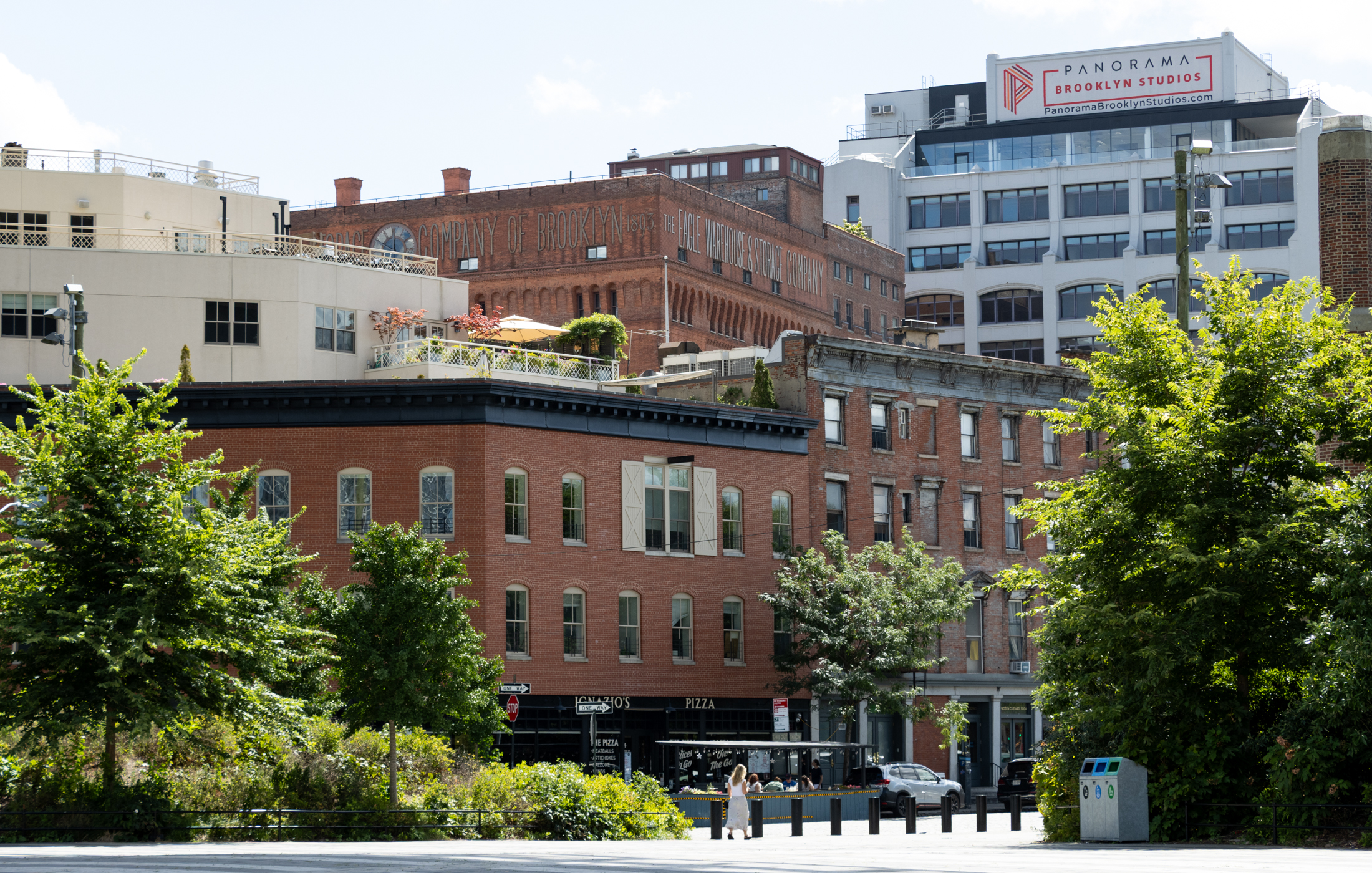 brick buildings in dumbo with larger buildings in brooklyn heights beyond