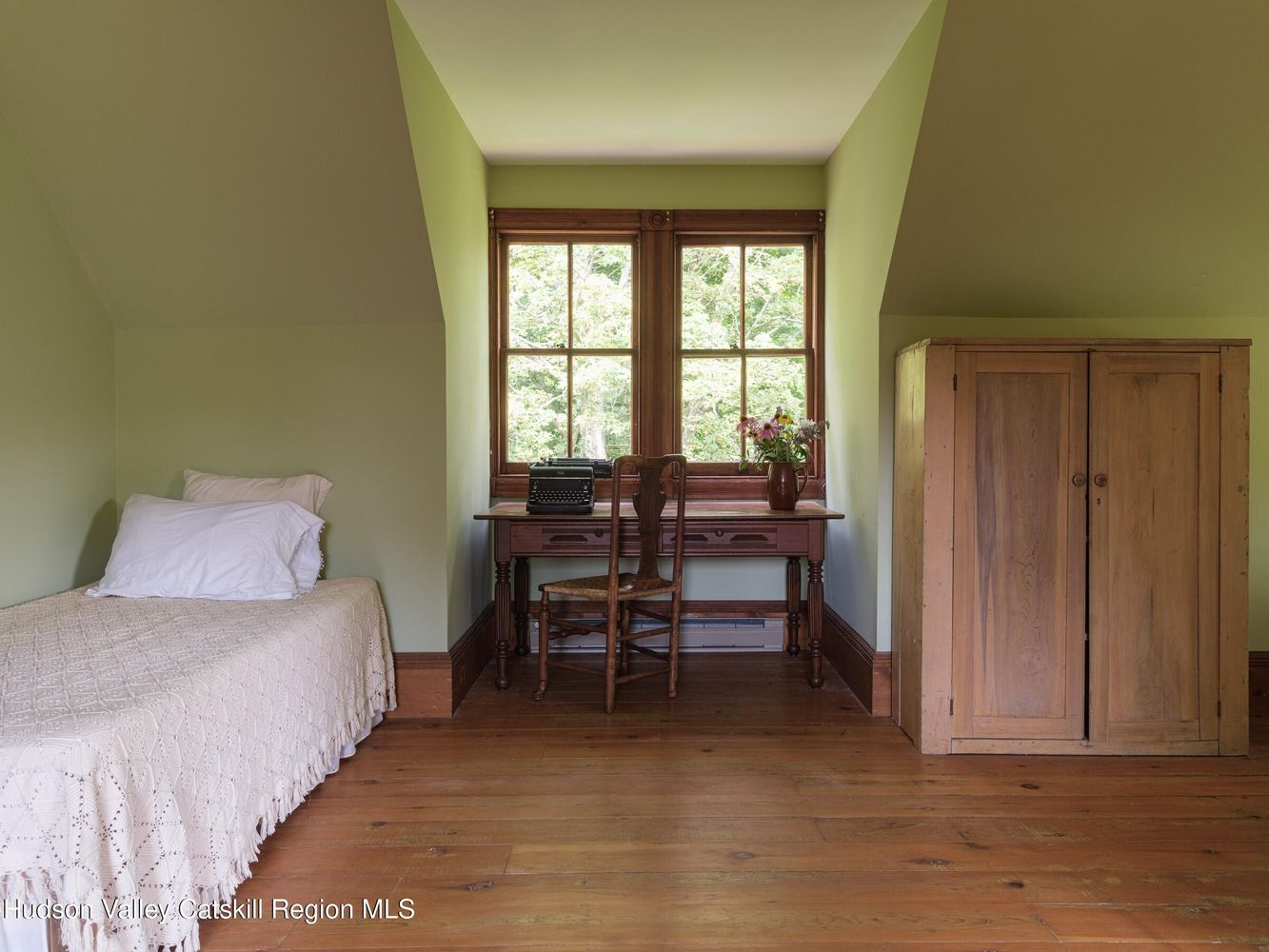 bedroom with slanted ceiling, wood floor