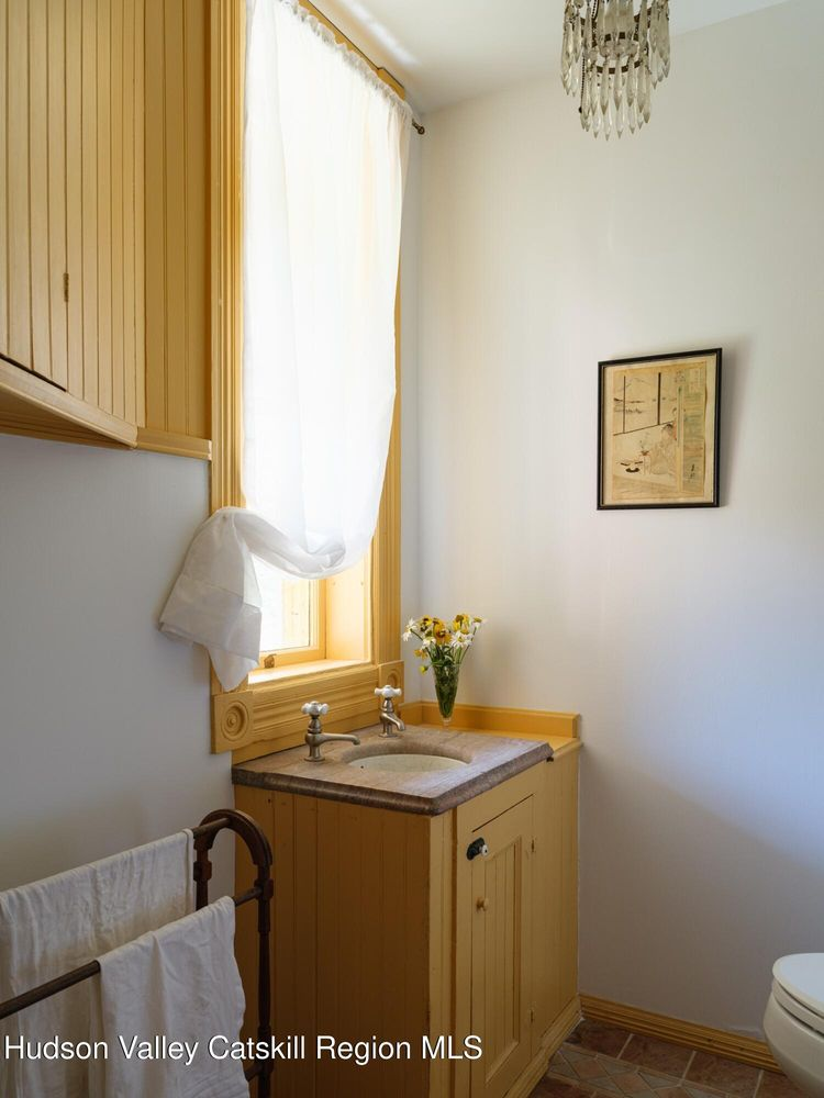 bathroom with yellow painted cupboards