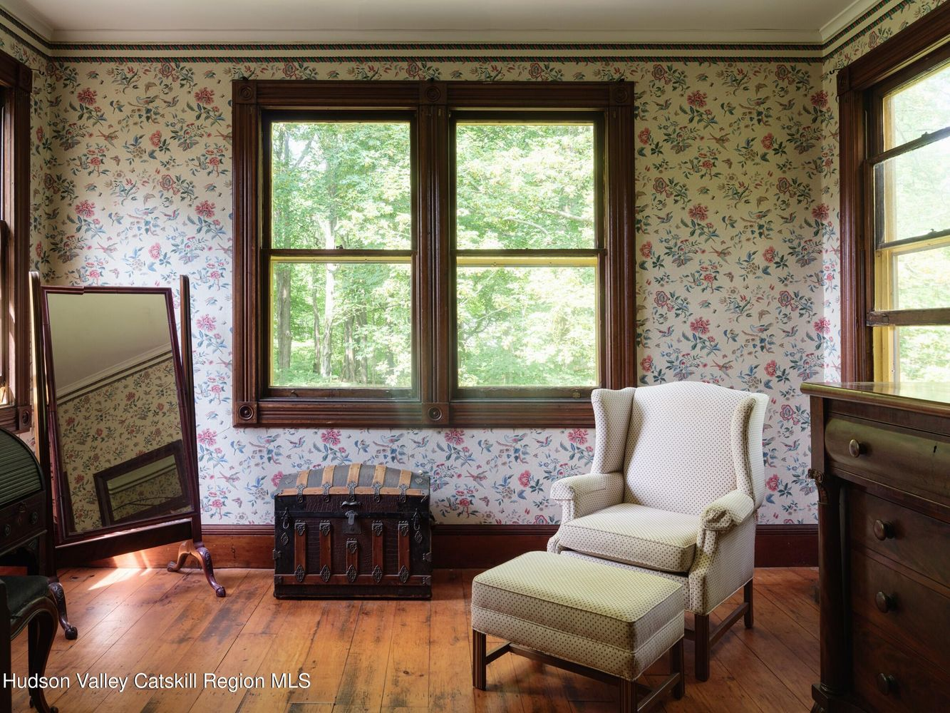 bedroom with wood floor, floral wallpaper