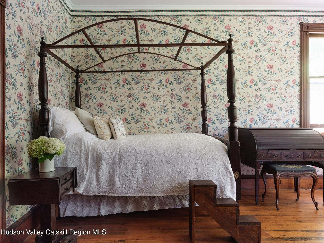 bedroom with wood floor, floral wallpaper