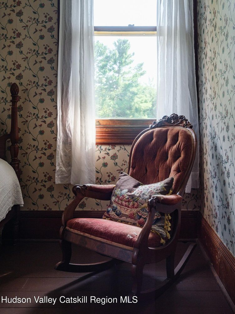 details of floral wallpaper and a rocker