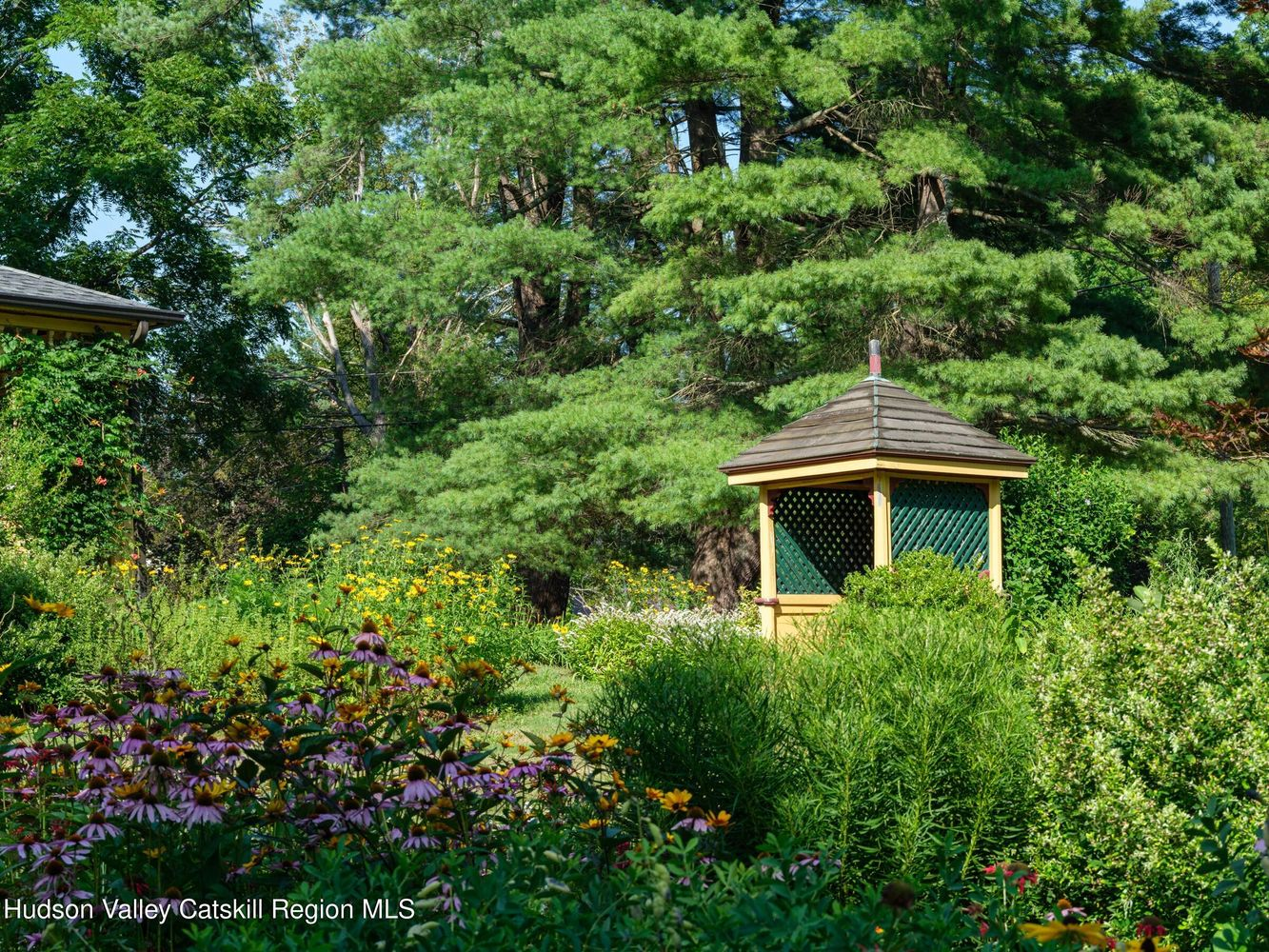 small wellhouse painted yellow and green