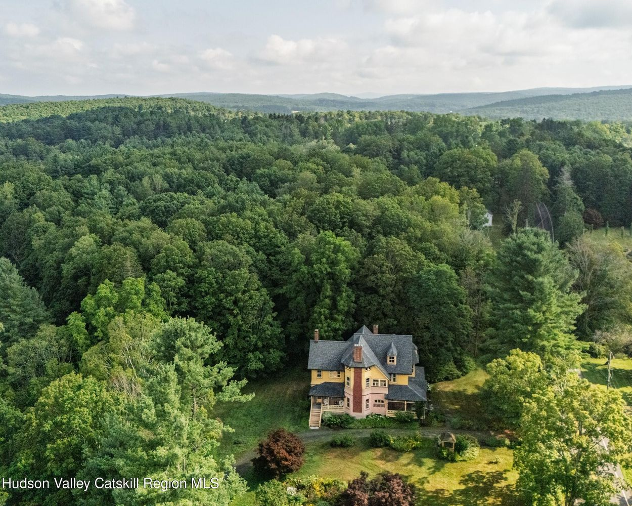 aerial view showing the house and a tree-filled surroundings