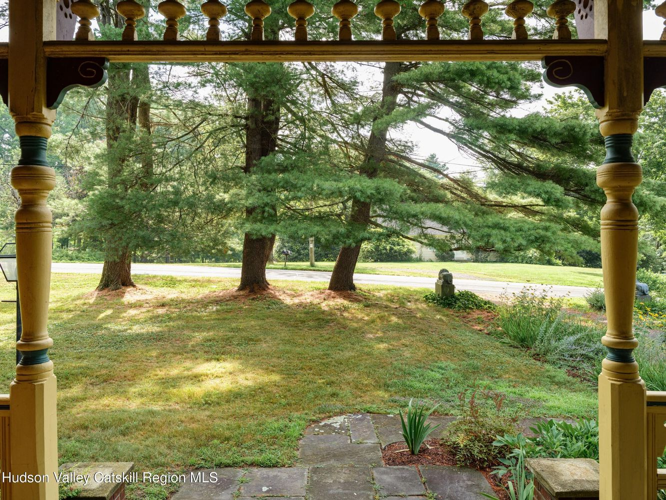 view from porch to a lawn with trees