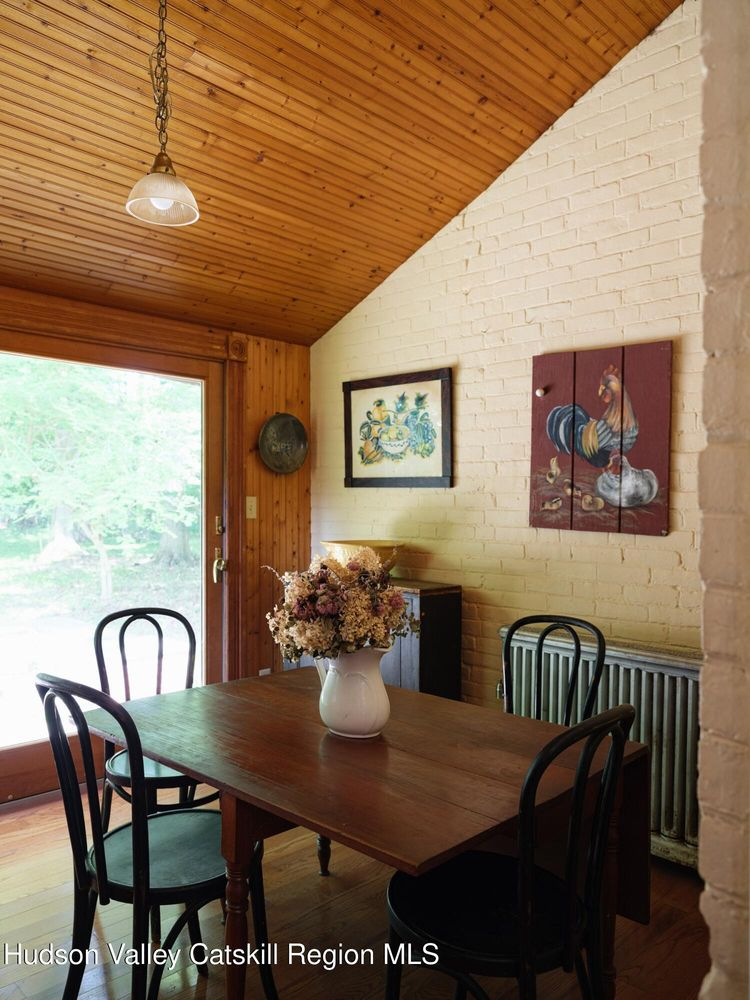 casual dining area off kitchen with slanted, wood slat ceiling