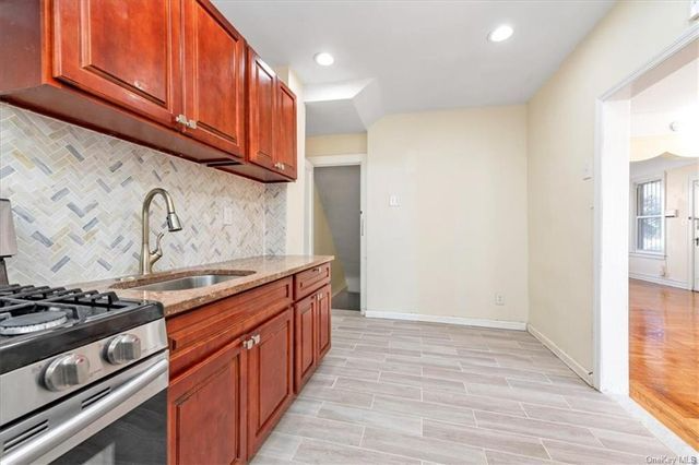 kitchen with tile floor, wood cabinets