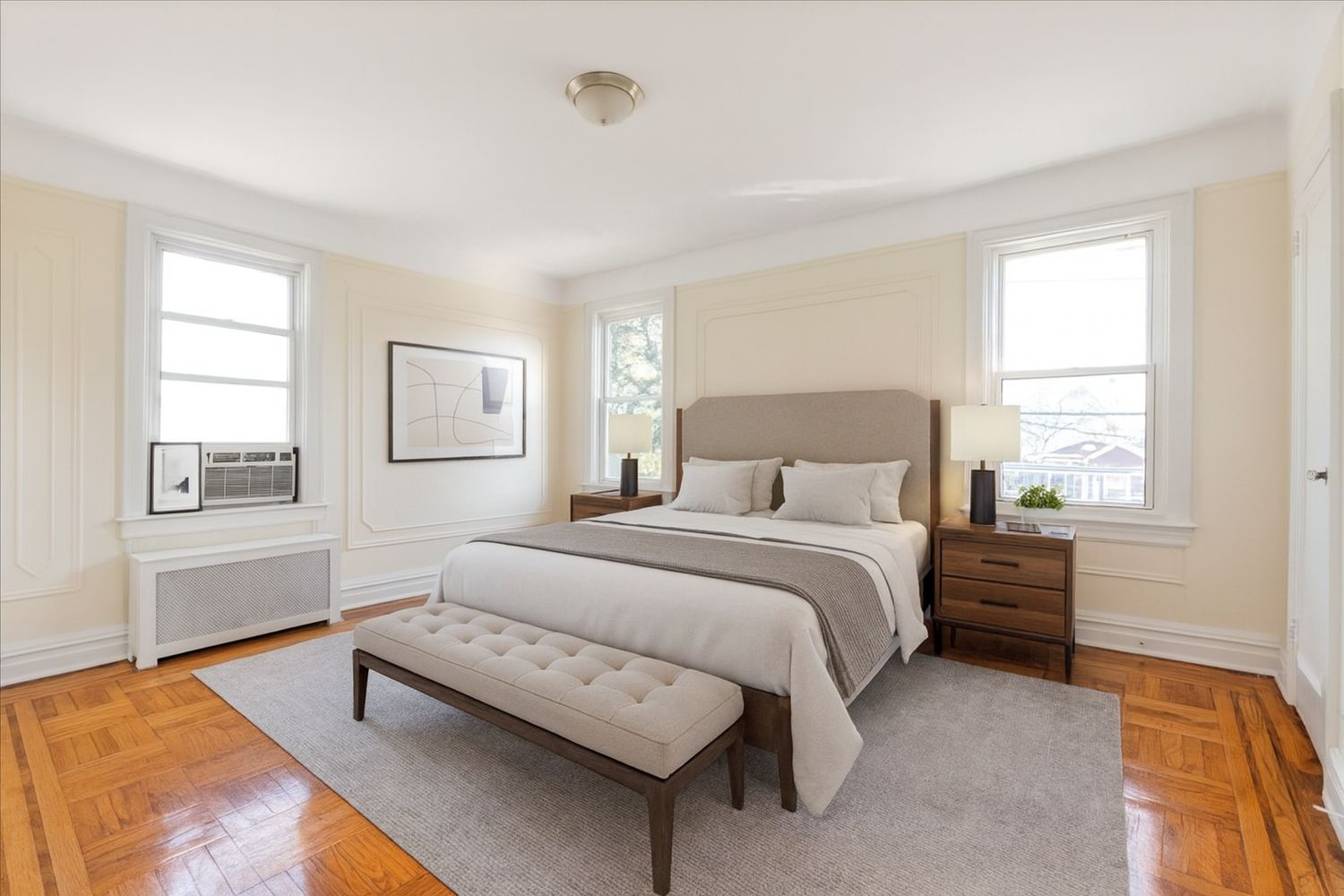 virtually staged bedroom with large bed, end tables