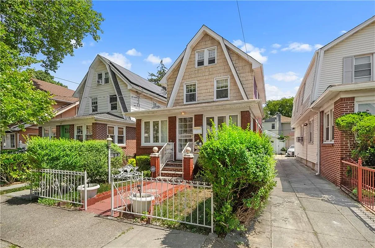 a detached house with a gambrel roofline
