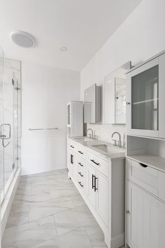 bathroom with white fixtures and tiles