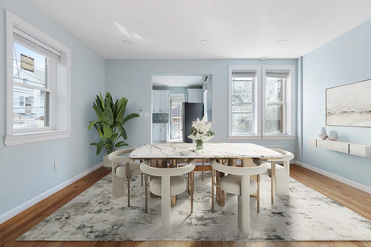 virtually staged dining room with room for a large table and a view into the kitchen