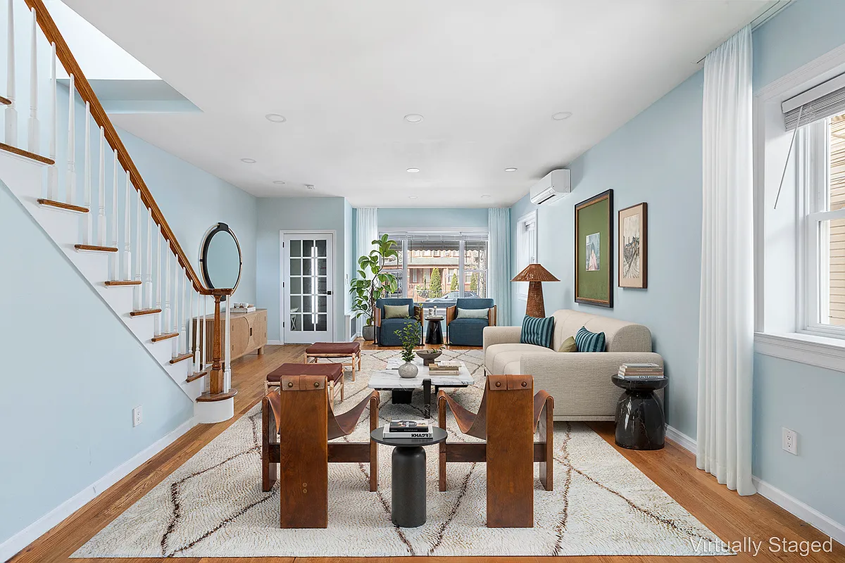 virtually staged living room with blue walls and room for two seating areas