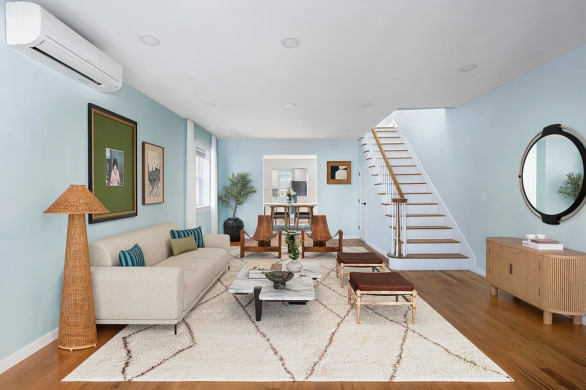 virtually staged living room with seating area, blue walls