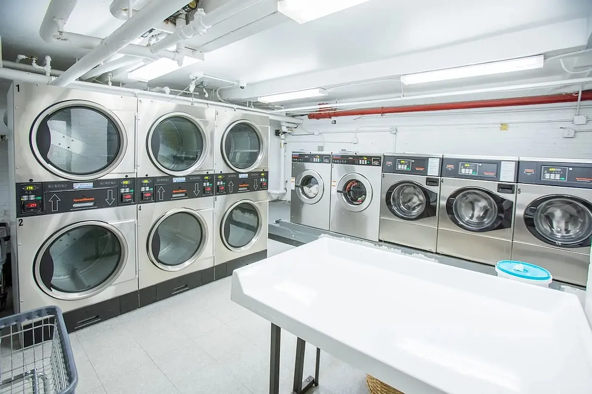 laundry room with multiple washers and dryers
